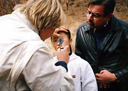 Rev. Tim Peters watches a North Korean woman examined by a doctor